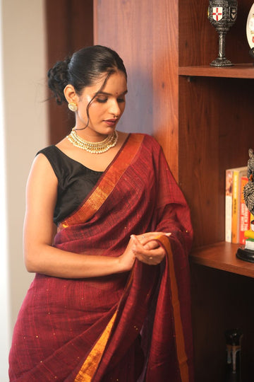Rudrani| Maroon linen saree with golden zari & sequin highlights